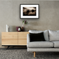 Framed and mounted photograph of kew bridge on the river thames in south west london hanging on a wall above a sofa and cupboard
