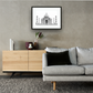 Framed and mounted black and white photograph of the Taj Mahal in Agra hanging on a wall above a sofa and cupboard